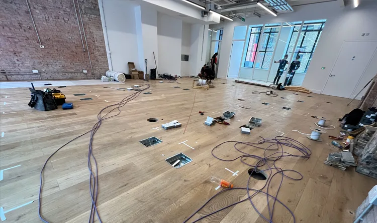 Axia Futures - Data infrastructure and fit-out phase including power and CAT6+ cabling going into raised access floor.